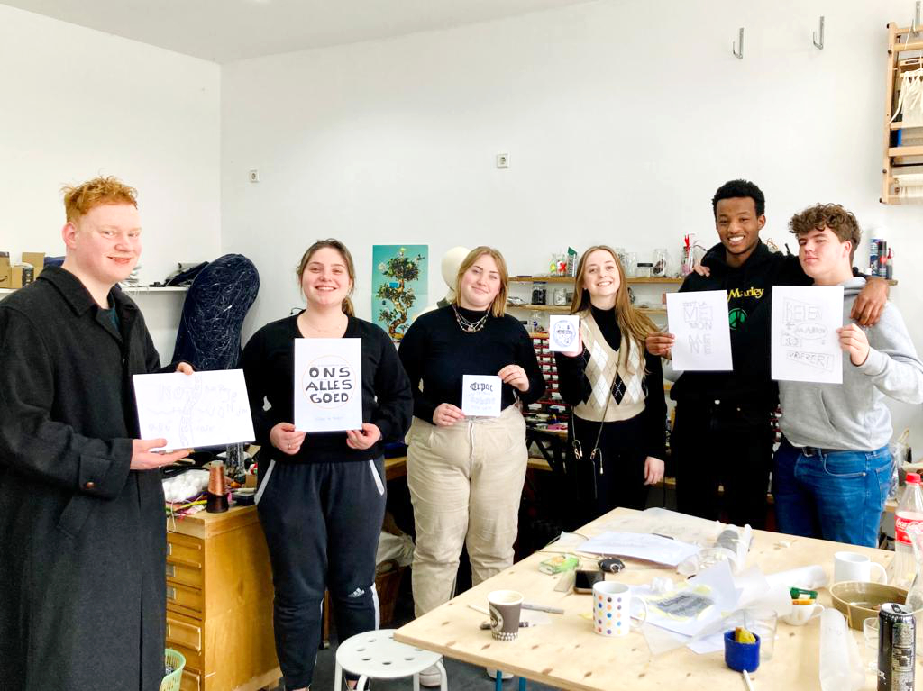 A group of dutch students showing off the results of a hand lettering workshop at Annemarie's studio